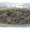 Rectangular compressed block with a layered interior and textured surface, photographed on a plain background.