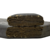Two rectangular pieces of compressed material stacked vertically, showing a dense interior with a textured surface on a plain background.