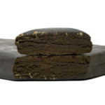 Two rectangular pieces of compressed material stacked vertically, showing a dense interior with a textured surface on a plain background.